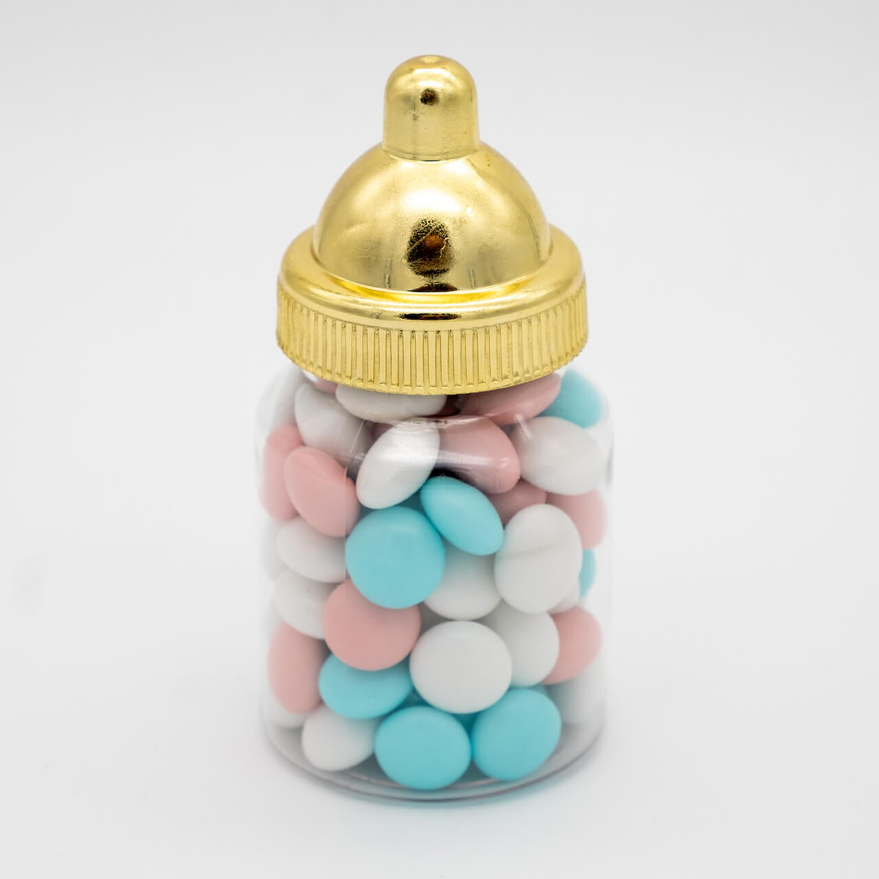Babyflesje met blauwe, roze en witte chocolade dragees en een goudkleurige dop